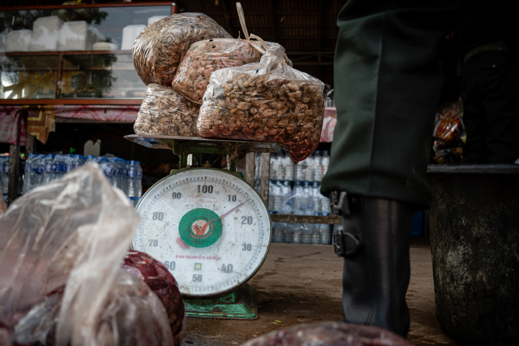 Rangers weighing wildlife meat in restaurant
