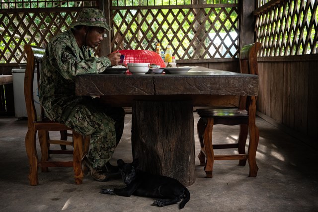 A Park Ranger eats at the station after long patrol